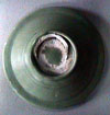 Underside of celadon plate T-983, showing remains of the circular tubular support stuck off-centre to the base.